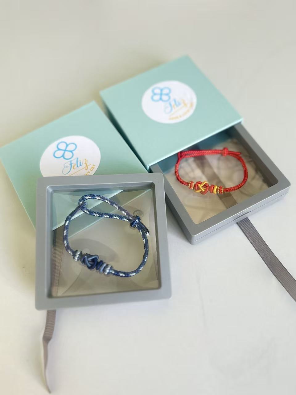 Original Feliz blue gift boxes with red and blue handmade bracelets